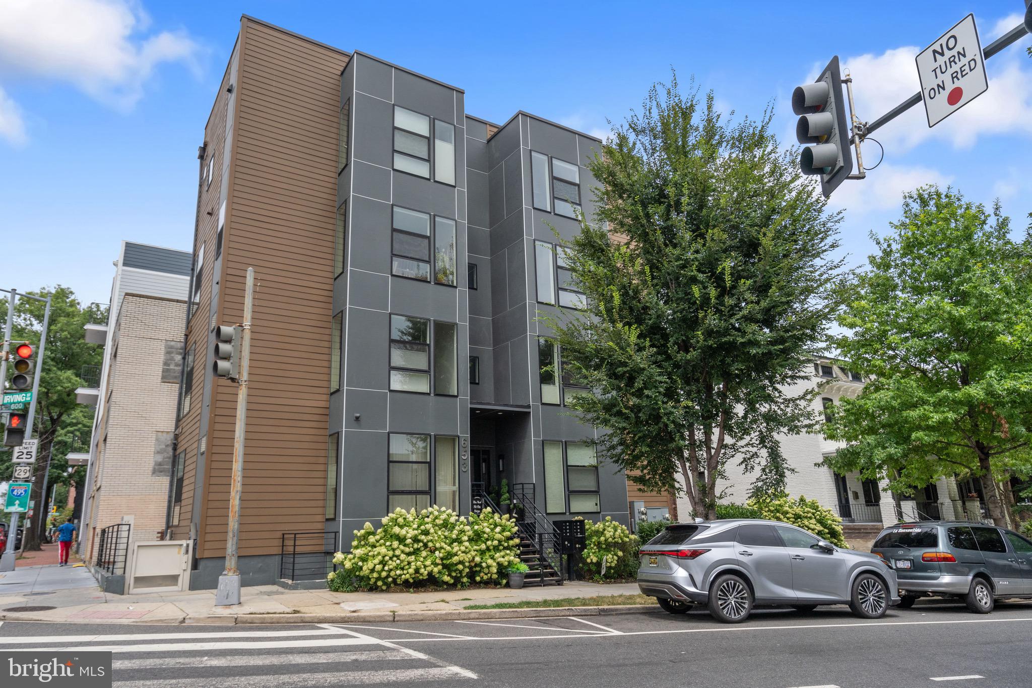 653 Irving Street Northwest, Unit 7 Washington, DC 20010 - Photo 28 of 31 a couple of cars parked in front of brick building