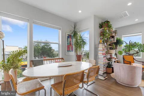 a view of a dining room with furniture and a potted plant