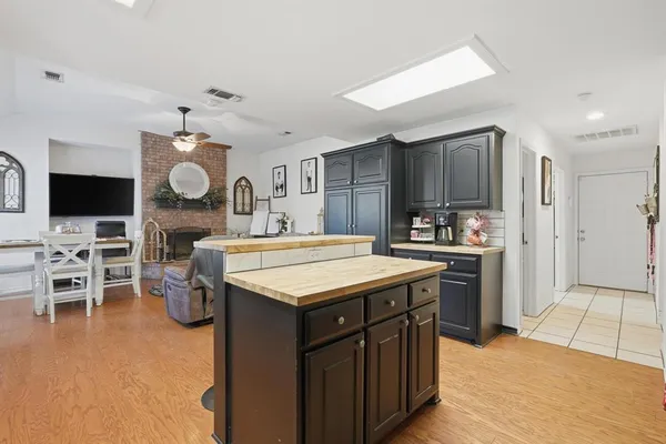 a kitchen with cabinets and chairs