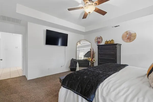 a bedroom with a bed and a flat tv screen