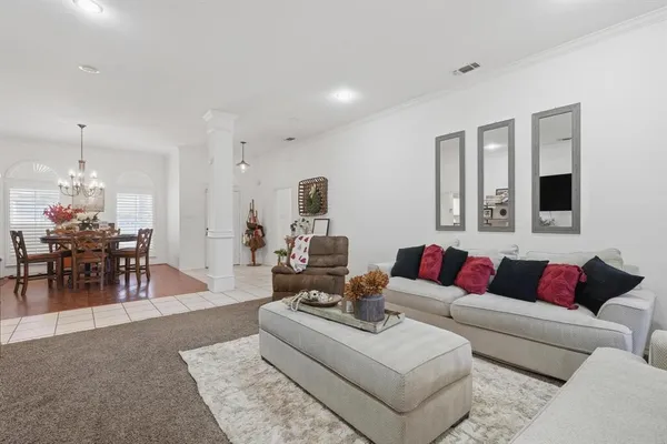 a living room with furniture and view of dining room