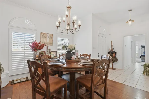 a view of a dining room with furniture and chandelier