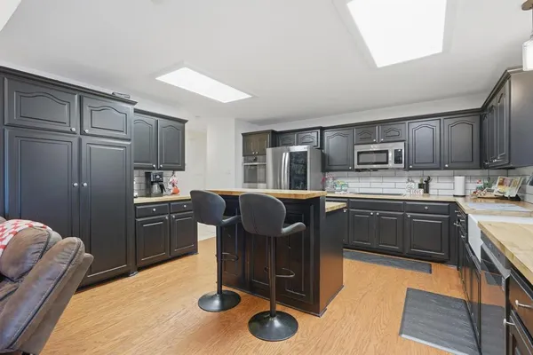a kitchen with granite countertop wooden cabinets and stainless steel appliances