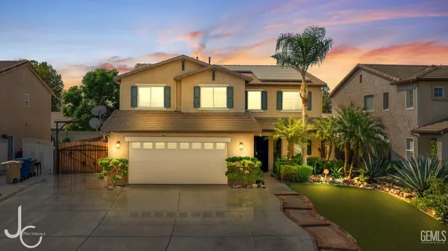 a front view of a house with yard