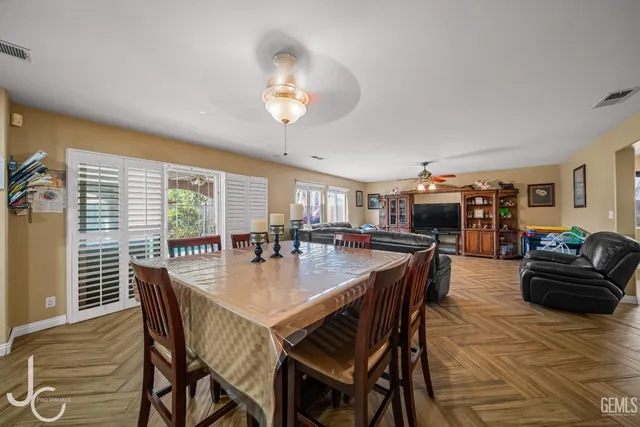 a dining room with furniture and wooden floor