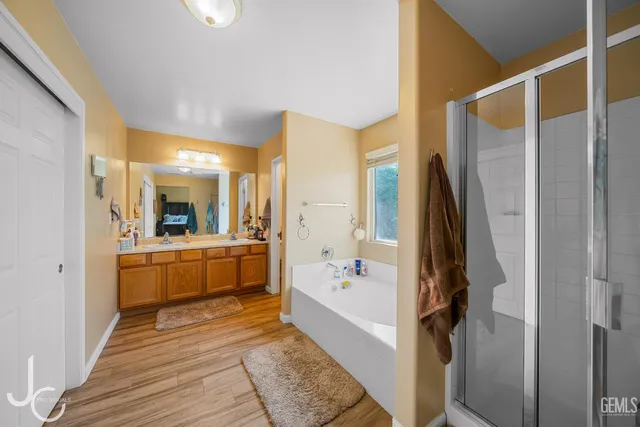 a bathroom with a tub sink and mirror