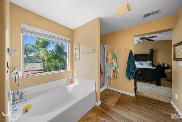 a bathroom with a tub and a shower