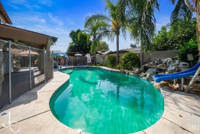 a swimming pool with outdoor seating and yard