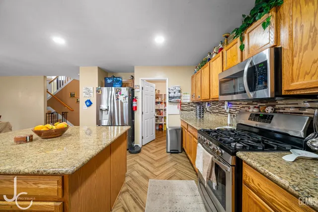 a kitchen with stainless steel appliances granite countertop a stove and a sink