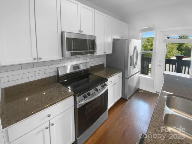 a view of an empty room with a ceiling fan
