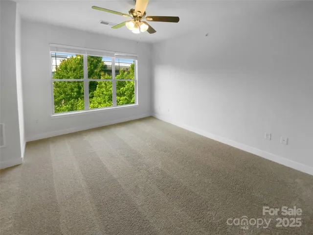 a view of room with window and ceiling fan