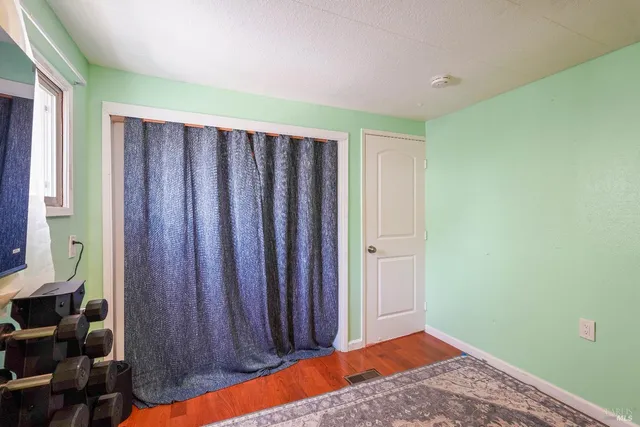 a view of a room with wooden floor and walls