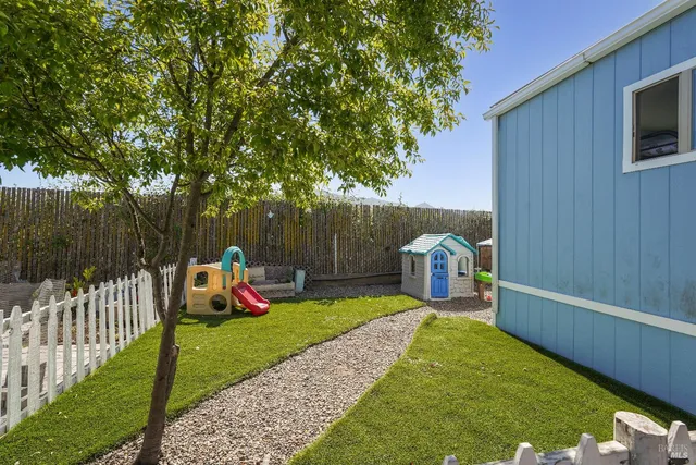 a view of a garden with wooden fence