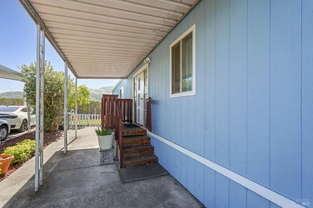 a view of balcony with wooden floor and fence