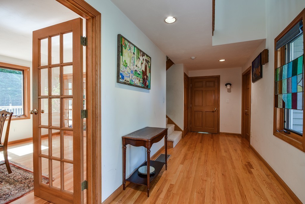 41 Garvey Road Framingham, MA 01701 - Photo 11 of 22 a view of hallway with windows and wooden floor