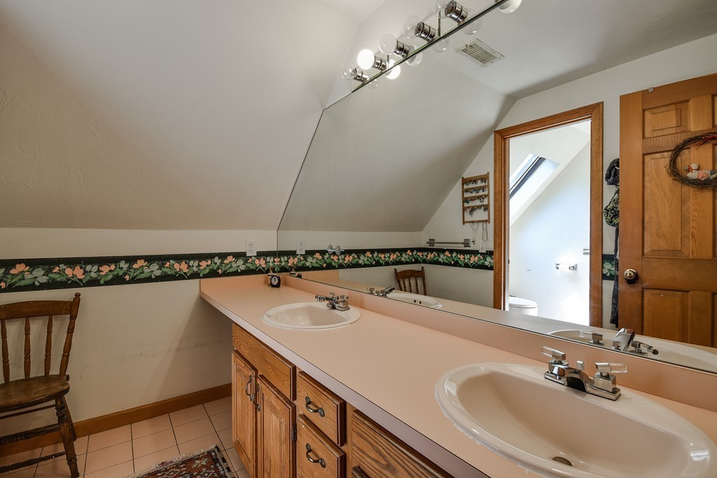 41 Garvey Road Framingham, MA 01701 - Photo 19 of 22 a bathroom with a sink and a mirror