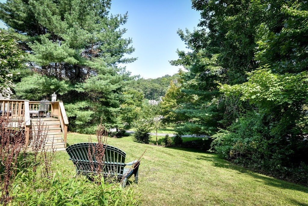 41 Garvey Road Framingham, MA 01701 - Photo 3 of 22 a view of a chair and table in the backyard