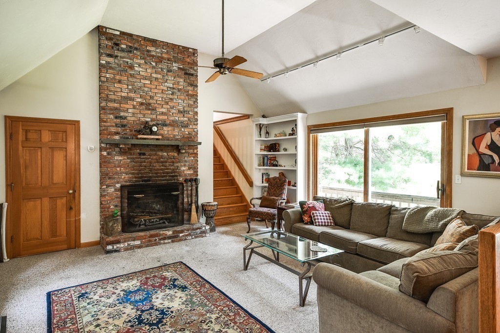 41 Garvey Road Framingham, MA 01701 - Photo 5 of 22 a living room with furniture a large window and a fireplace