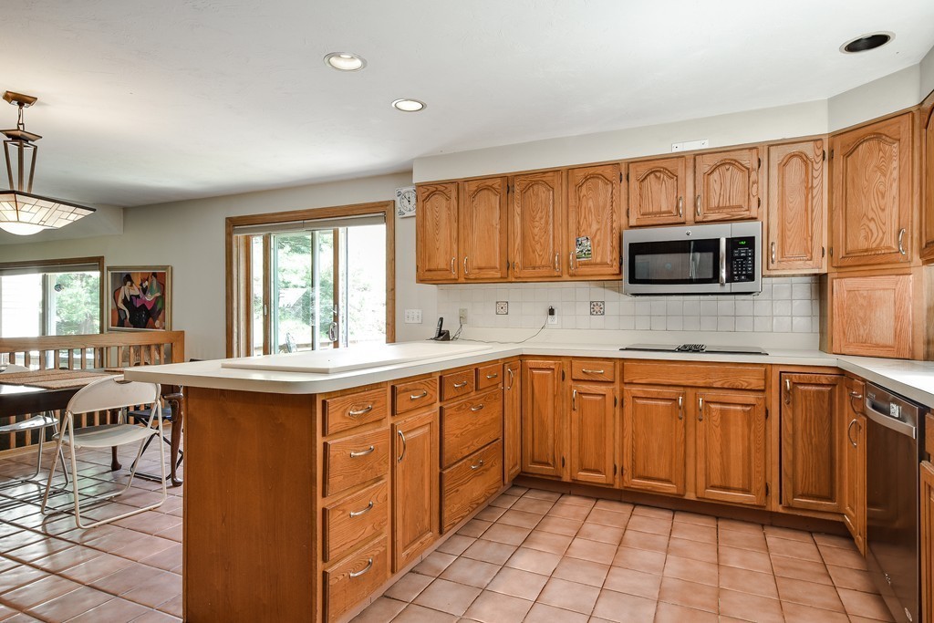 41 Garvey Road Framingham, MA 01701 - Photo 7 of 22 a kitchen with stainless steel appliances granite countertop a sink stove and microwave