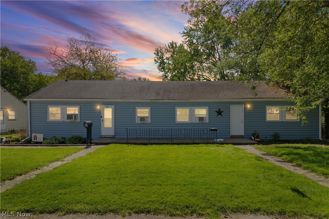 Duplex property featuring blue siding, white trim, and a dark shingle roof