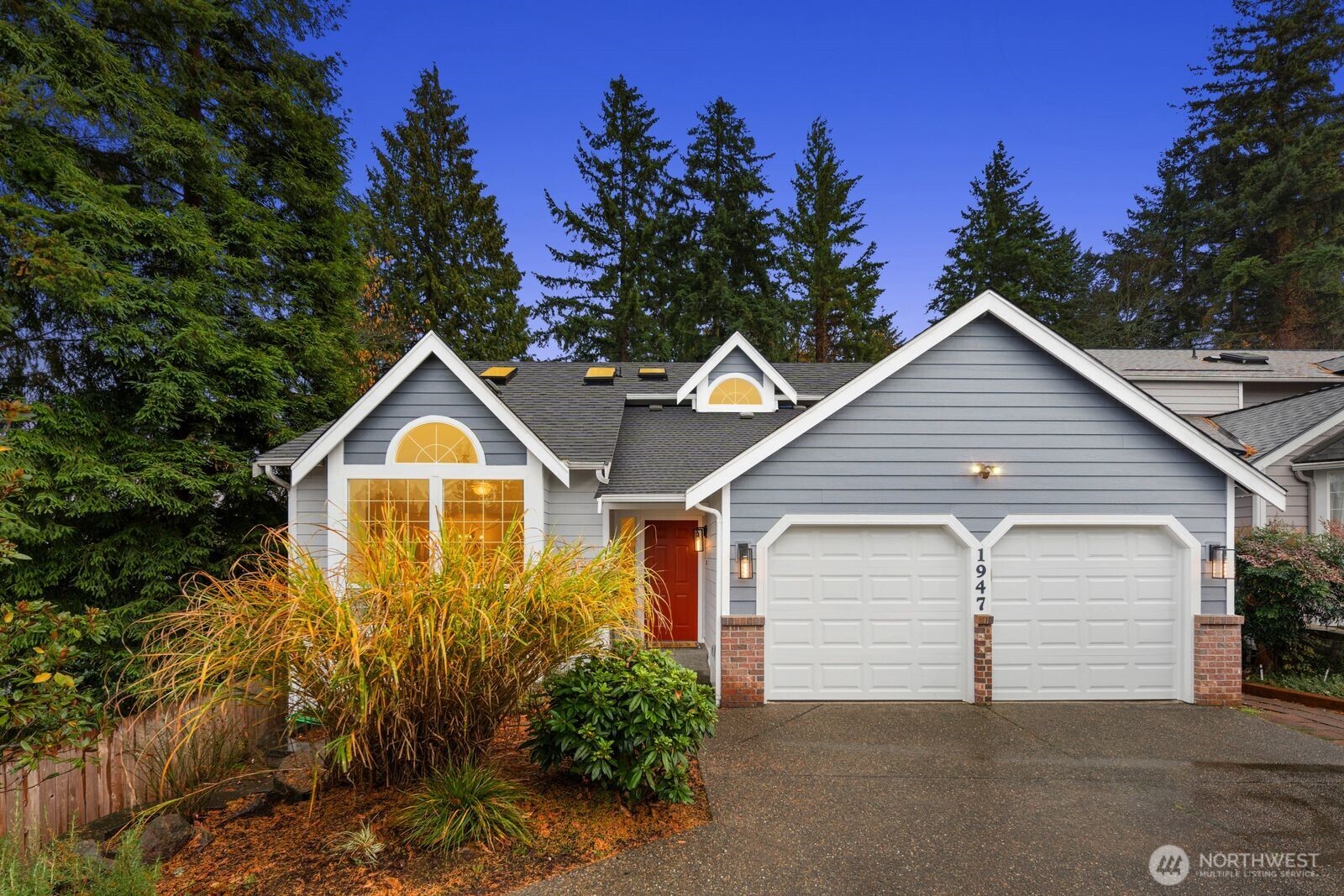 a view of a house with a yard and garage