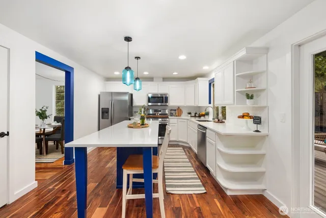 a large kitchen with a table and chairs