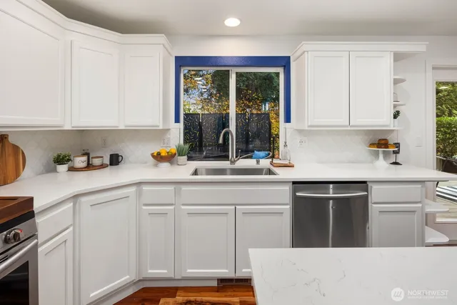 a kitchen with a sink stove and cabinets