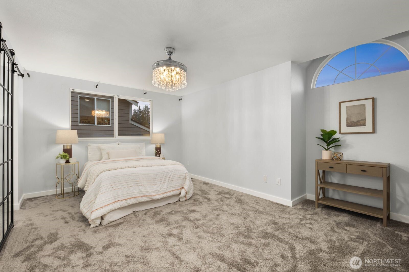 1947 Northeast 23rd Street Renton, WA 98056 - Photo 24 of 36 a bedroom with a bed and a chandelier