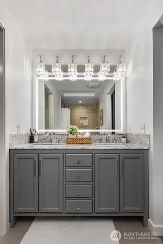 a bathroom with a granite countertop sink and a mirror