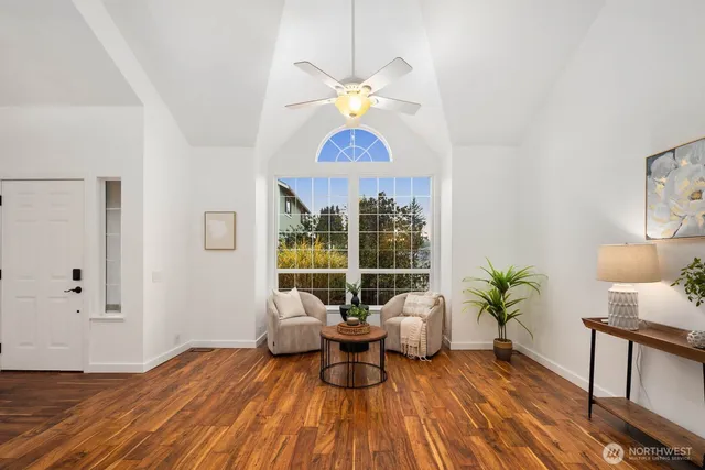 a living room with furniture and a chandelier