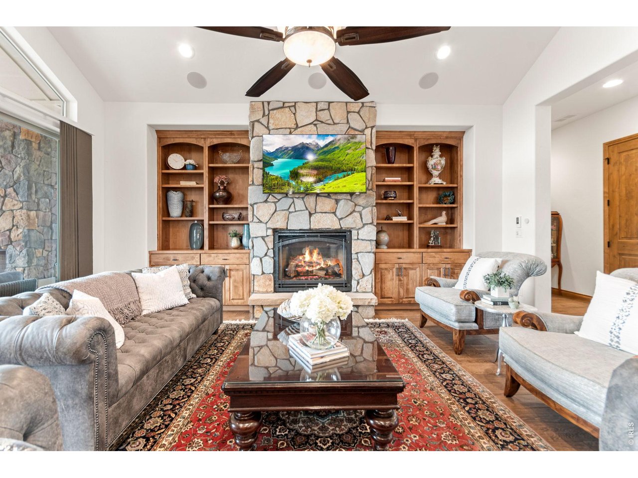 9567 Poppy Way Arvada, CO 80007 - Photo 13 of 48 a living room with furniture a fireplace and a chandelier