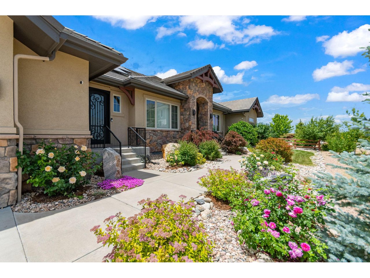 9567 Poppy Way Arvada, CO 80007 - Photo 2 of 48 a view of a house with a lot of flower plants