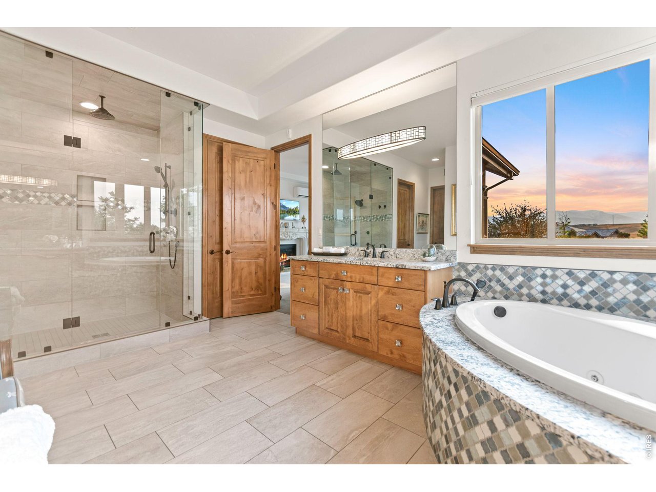 9567 Poppy Way Arvada, CO 80007 - Photo 26 of 48 a spacious bathroom with a tub sink shower and mirror