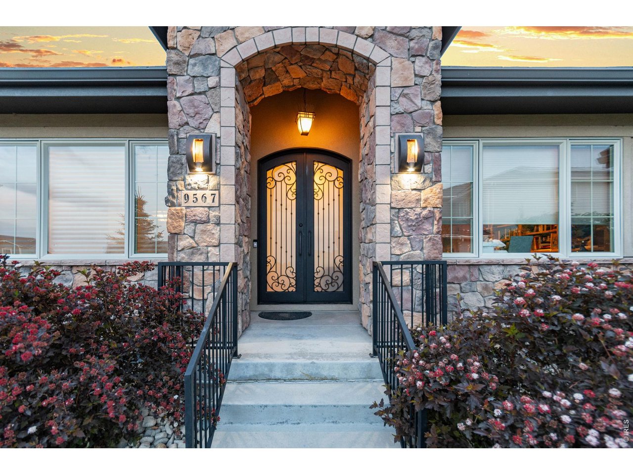 9567 Poppy Way Arvada, CO 80007 - Photo 3 of 48 a view of a house with a porch and flowers