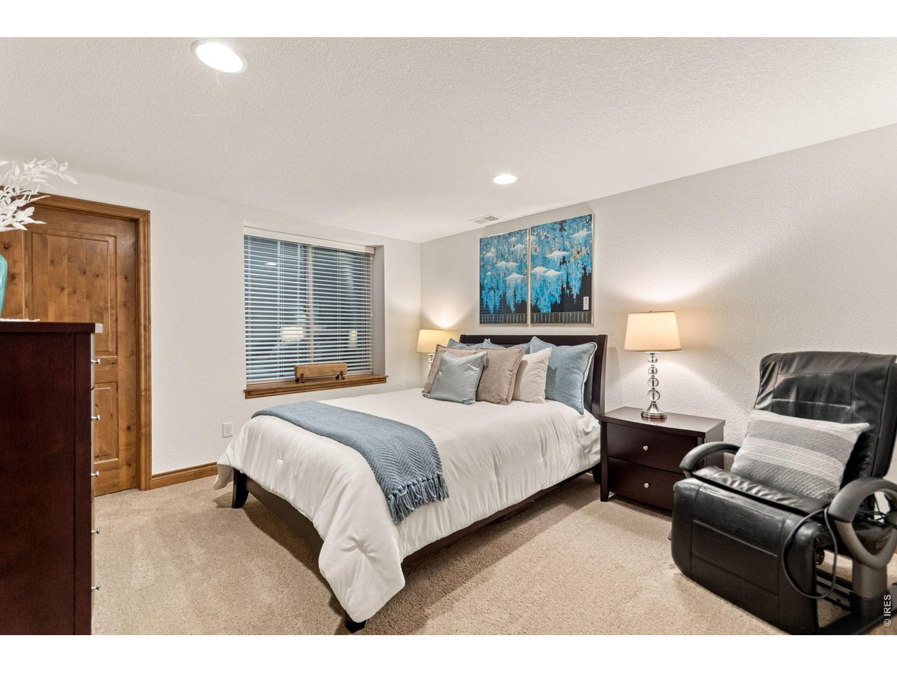 9567 Poppy Way Arvada, CO 80007 - Photo 35 of 48 a spacious bedroom with a bed and wooden floor