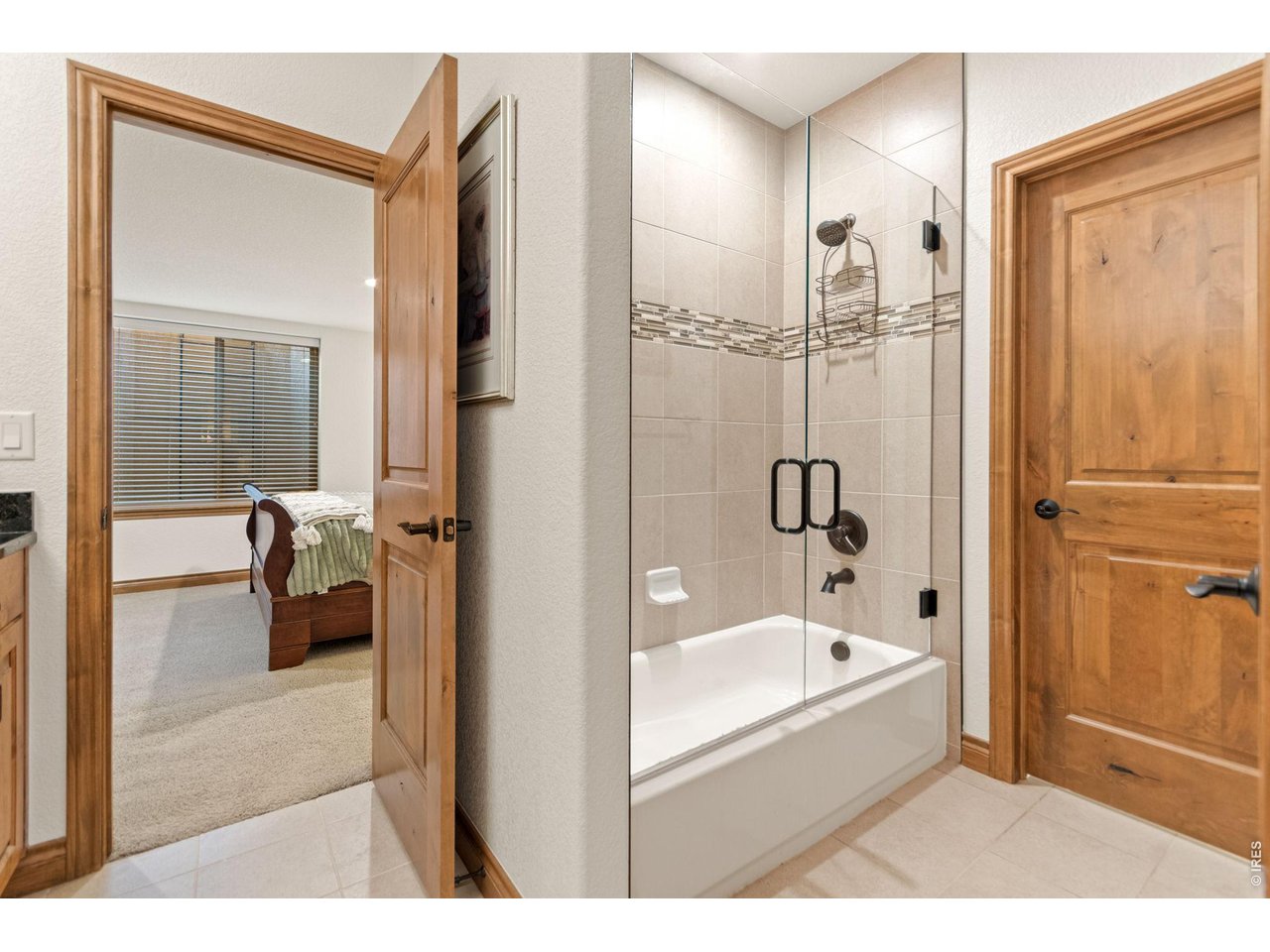9567 Poppy Way Arvada, CO 80007 - Photo 37 of 48 a en suite bathroom with a tub shower and bedroom view