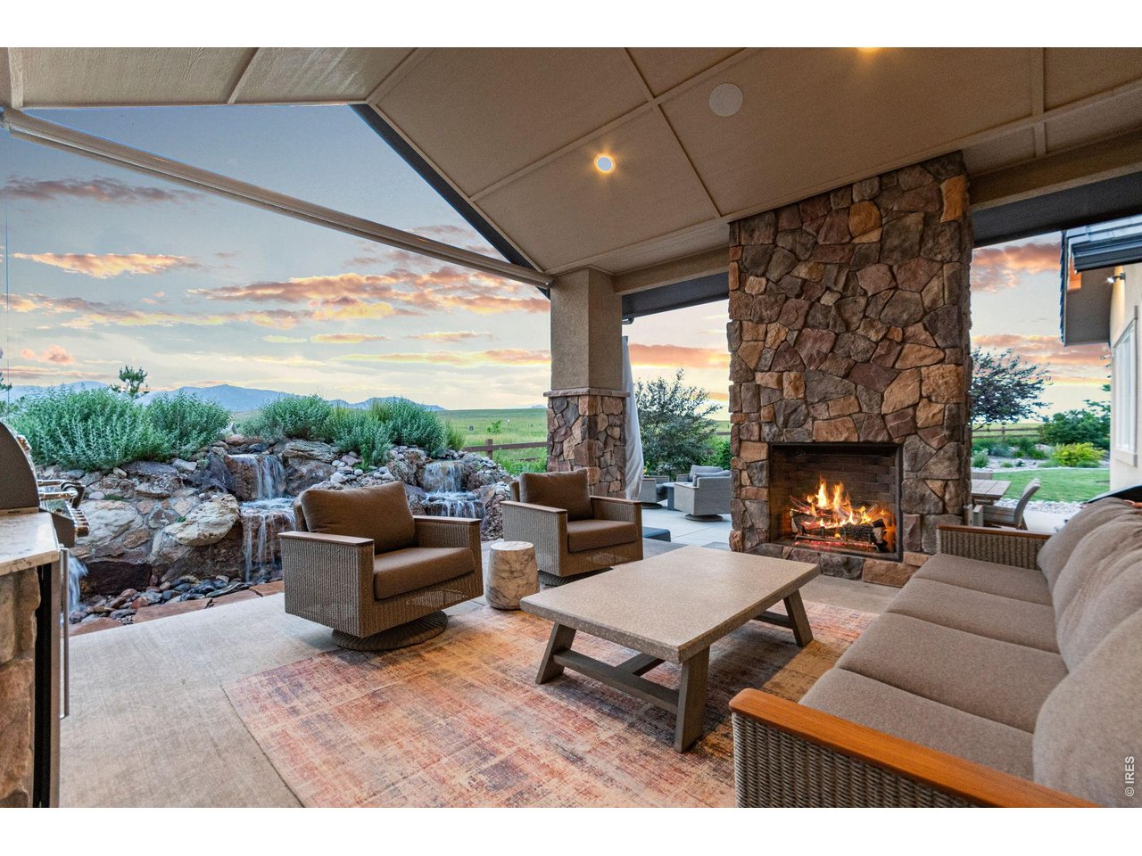 9567 Poppy Way Arvada, CO 80007 - Photo 42 of 48 a living room with furniture a fireplace and a floor to ceiling window