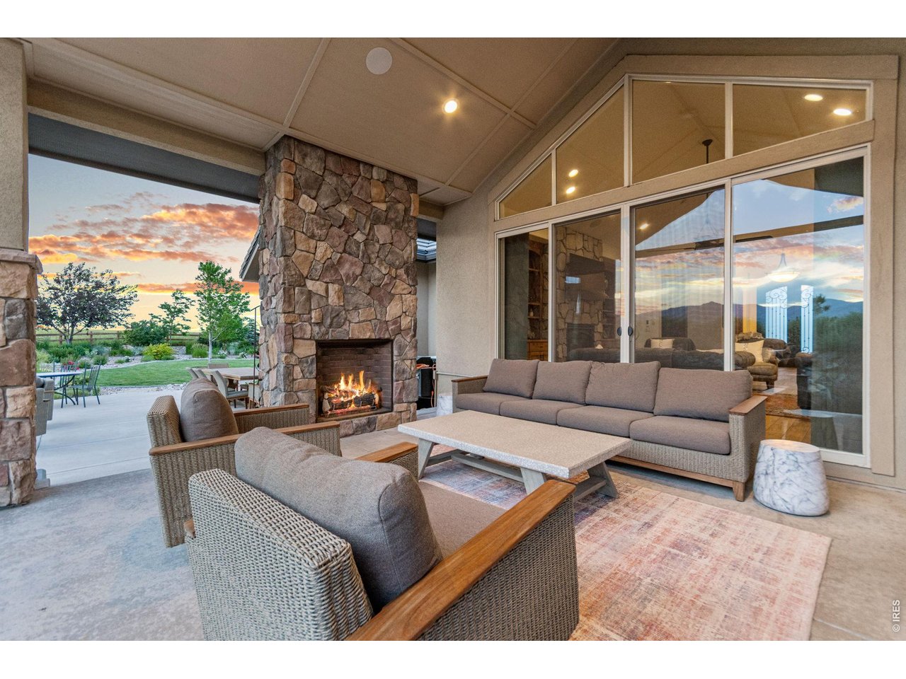 9567 Poppy Way Arvada, CO 80007 - Photo 43 of 48 a living room with furniture a fireplace and a floor to ceiling window