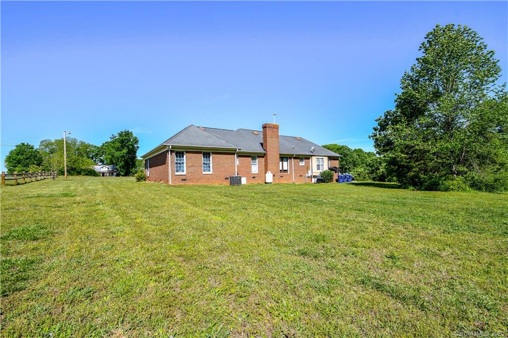 1408 Mills Harris Road Wingate, NC 28174 - Photo 2 of 23 a front view of a house with garden