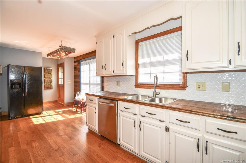1408 Mills Harris Road Wingate, NC 28174 - Photo 13 of 23 a kitchen with granite countertop a sink cabinets stainless steel appliances and a counter top space