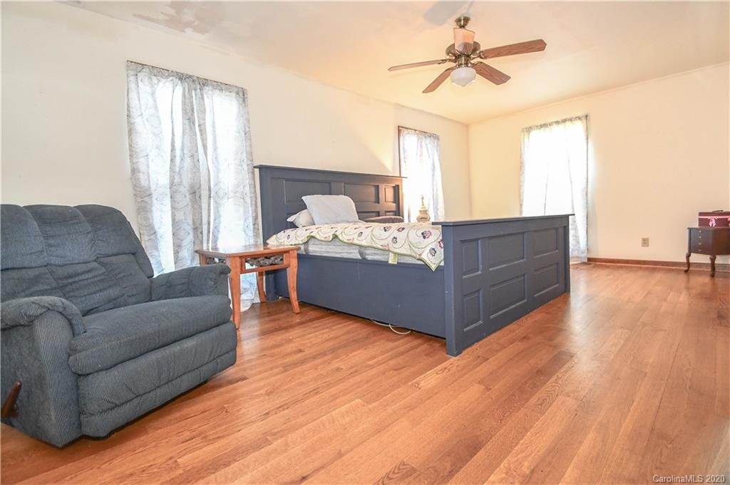 1408 Mills Harris Road Wingate, NC 28174 - Photo 16 of 23 a living room with furniture and a chandelier