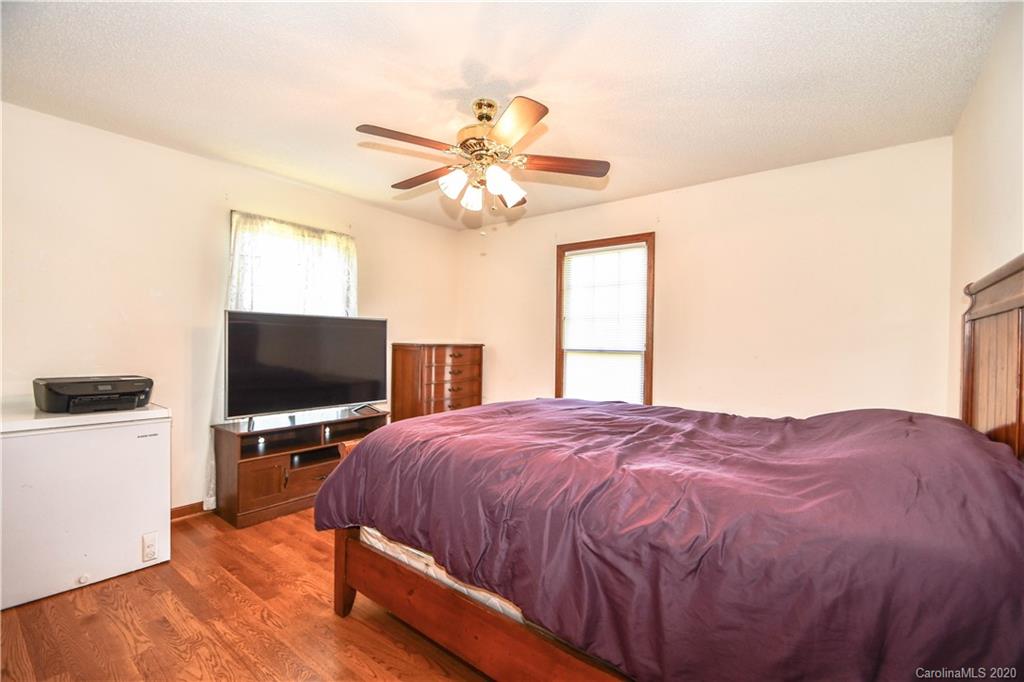 1408 Mills Harris Road Wingate, NC 28174 - Photo 18 of 23 a bedroom with a bed and a flat screen tv