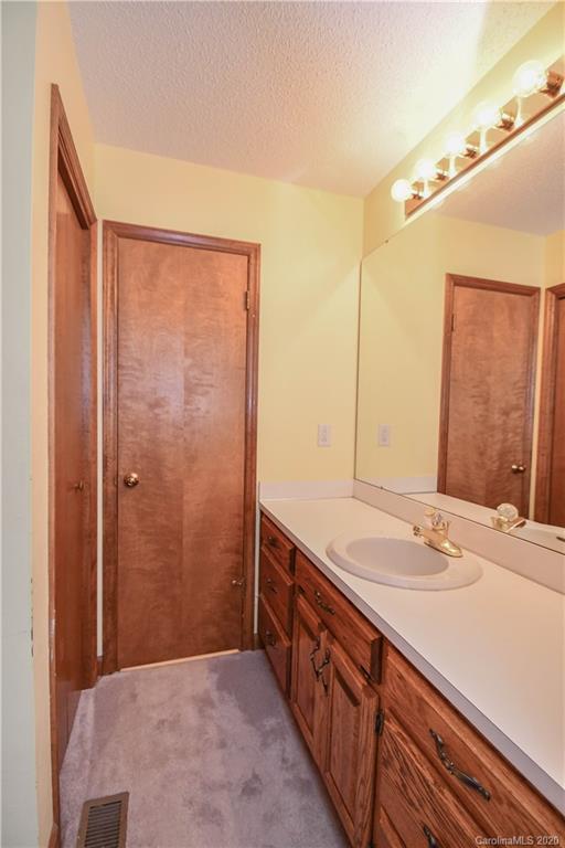 1408 Mills Harris Road Wingate, NC 28174 - Photo 19 of 23 a bathroom with a sink and a mirror