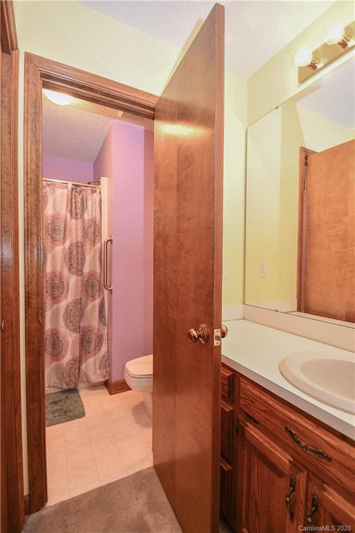 1408 Mills Harris Road Wingate, NC 28174 - Photo 20 of 23 a bathroom with a shower curtain and a sink