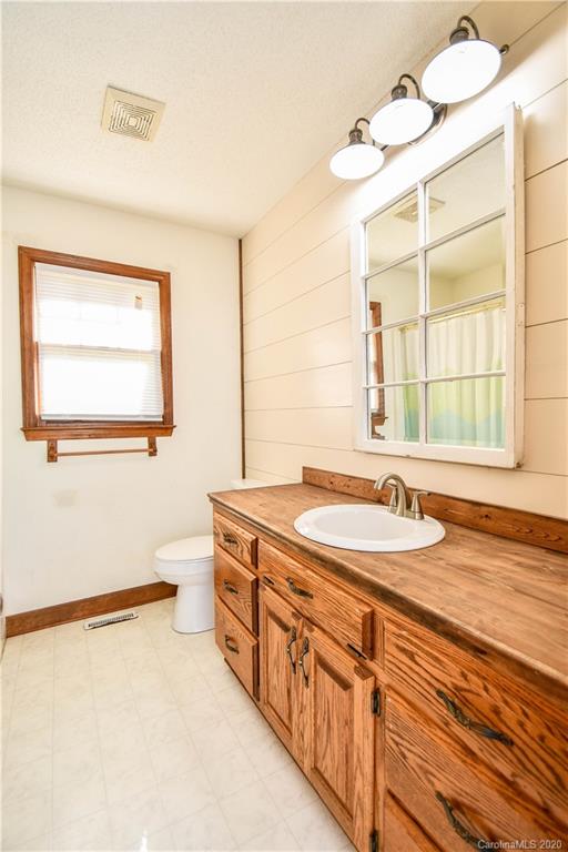 1408 Mills Harris Road Wingate, NC 28174 - Photo 22 of 23 a bathroom with a granite countertop sink and a window