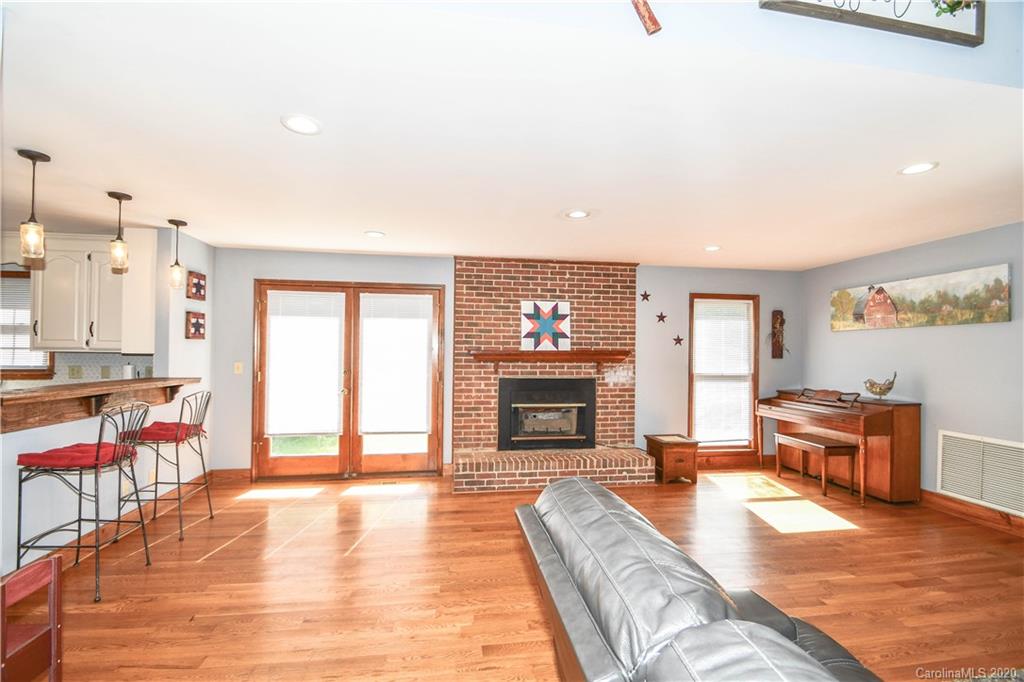 1408 Mills Harris Road Wingate, NC 28174 - Photo 5 of 23 a living room with furniture a fireplace and a flat screen tv