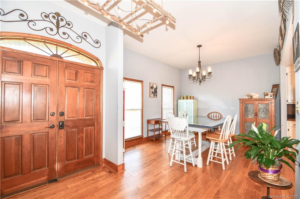 1408 Mills Harris Road Wingate, NC 28174 - Photo 7 of 23 a view of a livingroom with furniture wooden floor and a chandelier