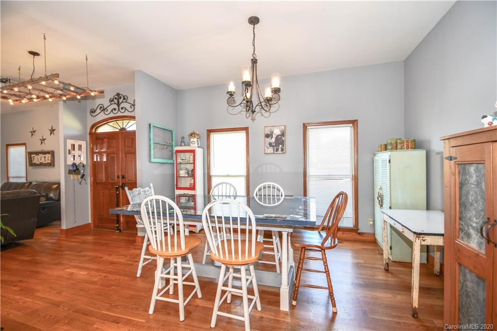 1408 Mills Harris Road Wingate, NC 28174 - Photo 9 of 23 a view of a dining room with furniture a chandelier and wooden floor