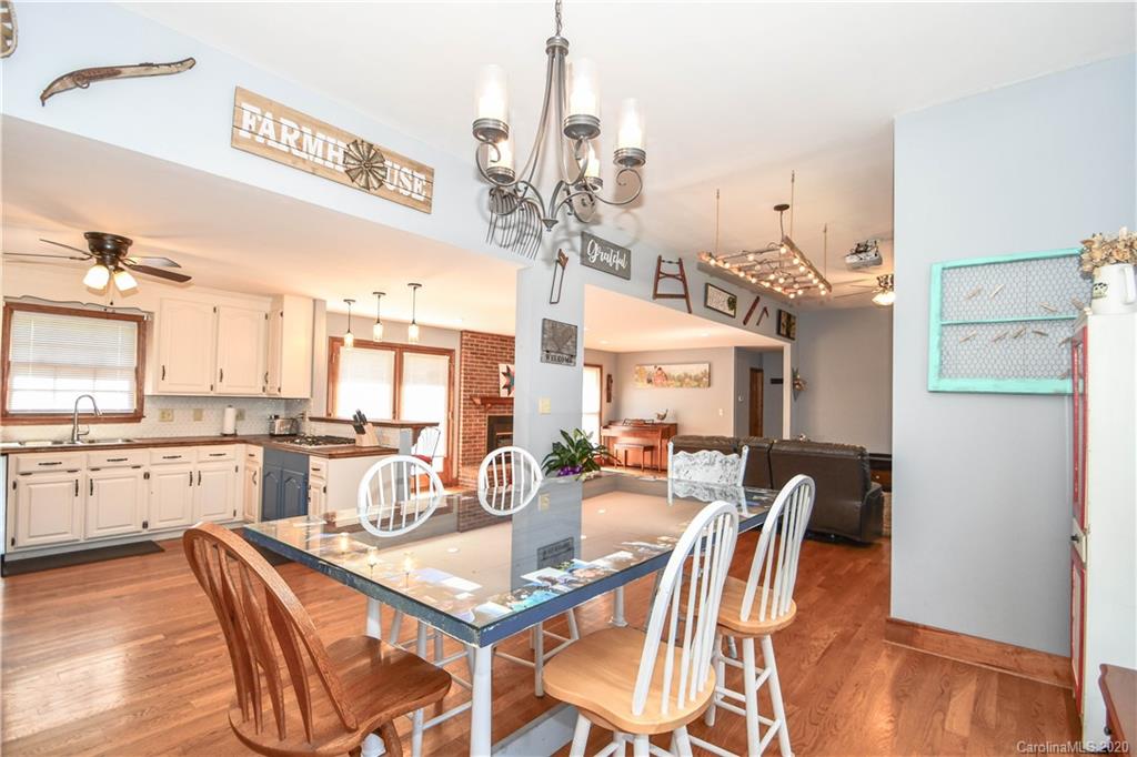 1408 Mills Harris Road Wingate, NC 28174 - Photo 10 of 23 a dining room with stainless steel appliances a table and chairs