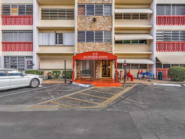 a living room with furniture a rug and a flat screen tv